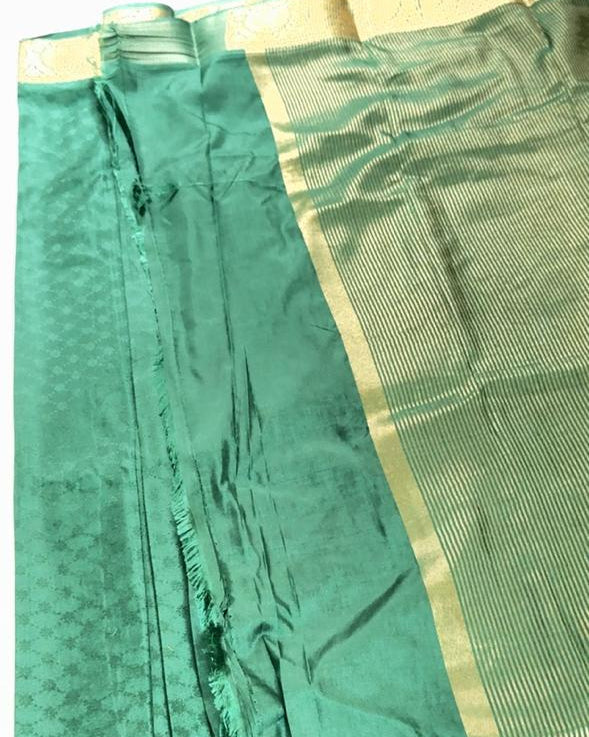 Green fabric with a gold border on a white background