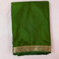 Green saree with a gold border on a white background