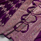 Purple fabric with intricate embroidery on a white background