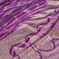 Purple fabric with intricate floral patterns on a white background