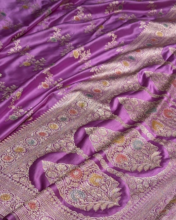Purple fabric with intricate floral patterns on a white background